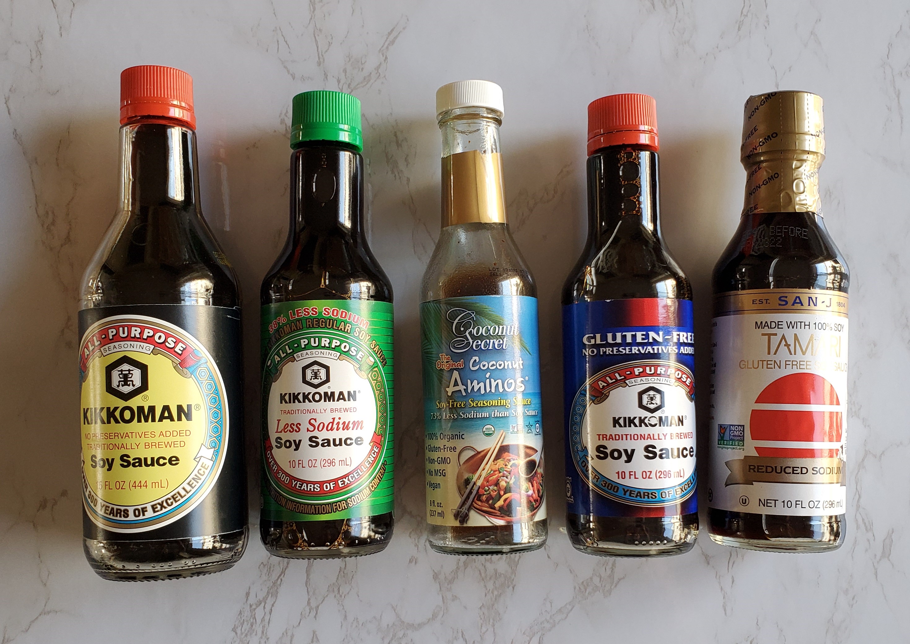 From left to right, Kikkoman Original Soy sauce, less sodium soy sauce, coconut aminos, GF soy sauce and Tamari.