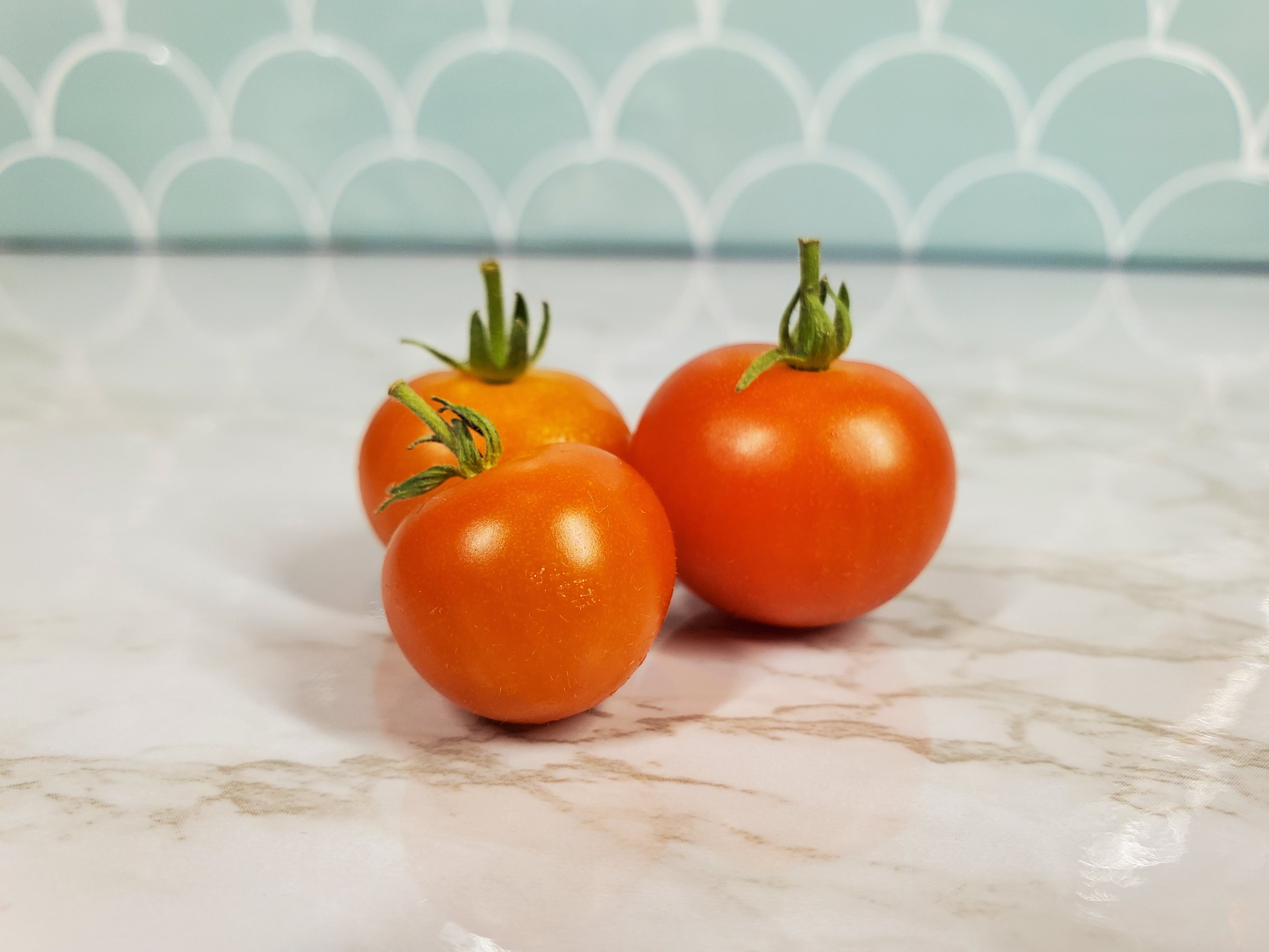 Fresh Cherry Tomatoes on the white granite countertop