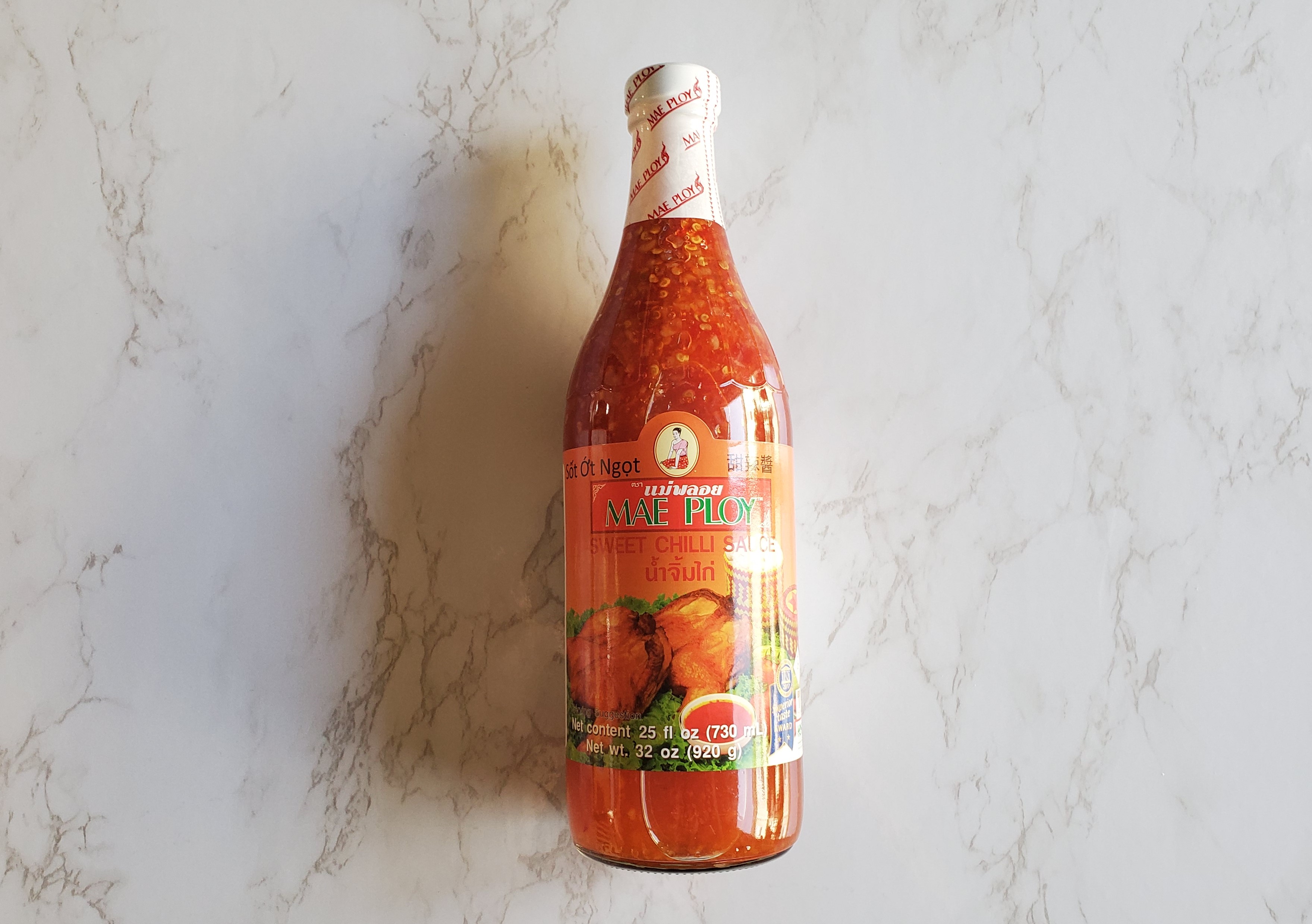 Sweet Chili Sauce on a white marble background.