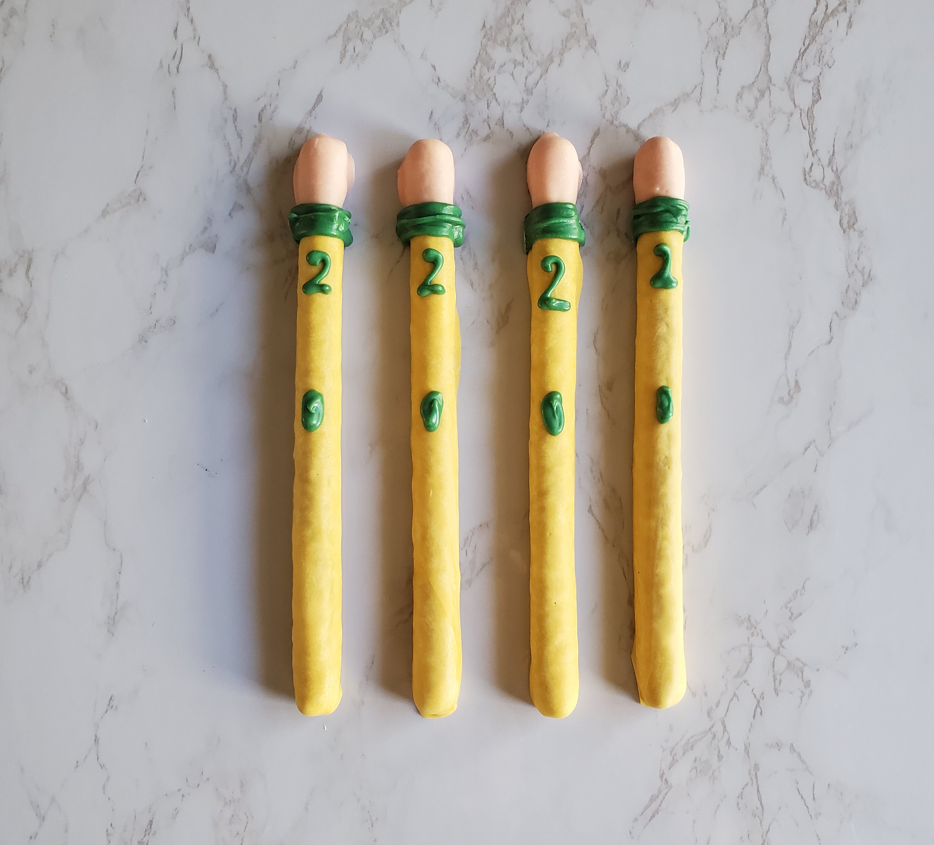 Four chocolate covered Pencil Pretzels