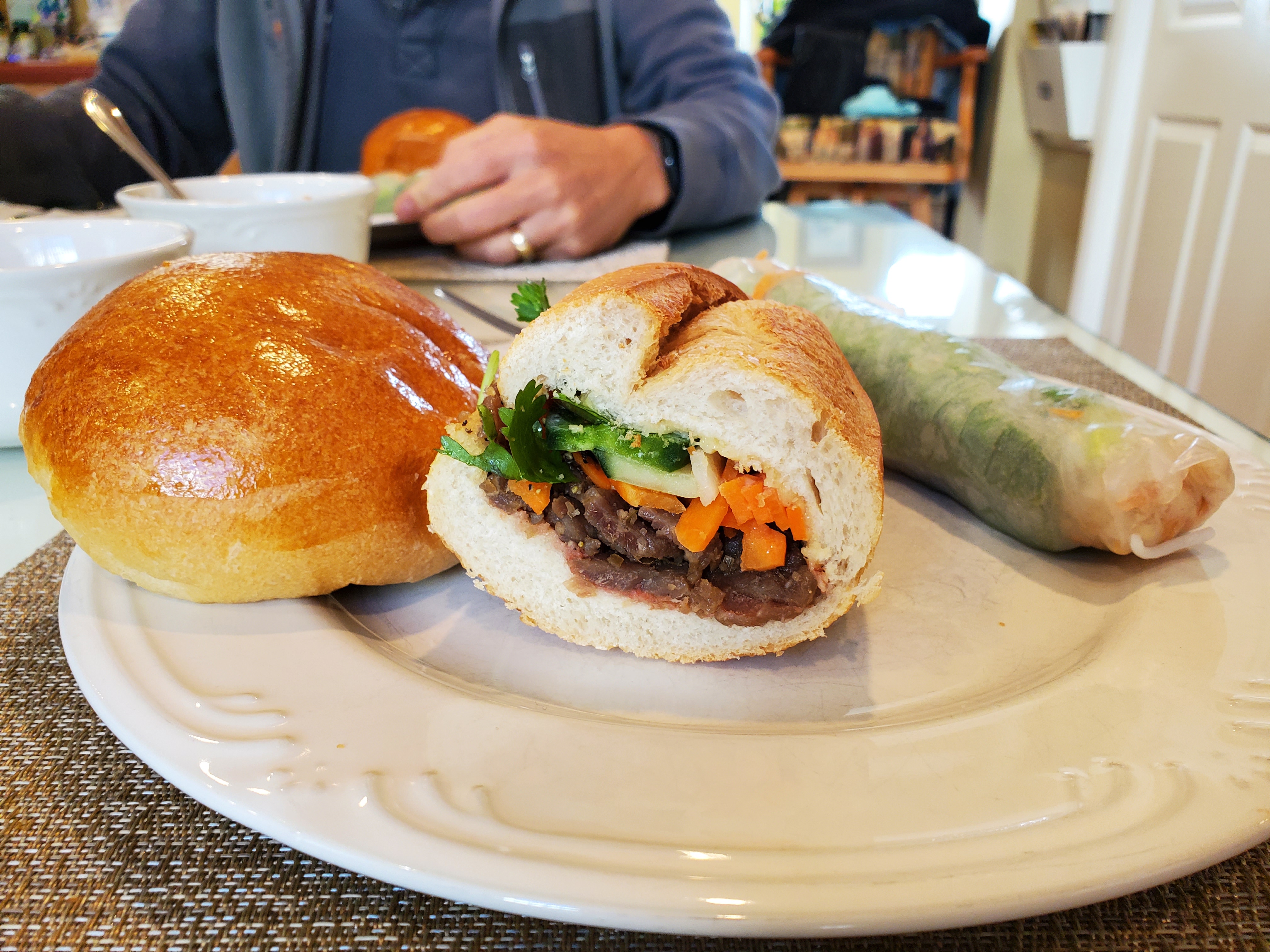 From left to right, Chinese bbq pork bun from Keefer Court, Banh mi sandwich and spring roll from My Huong.