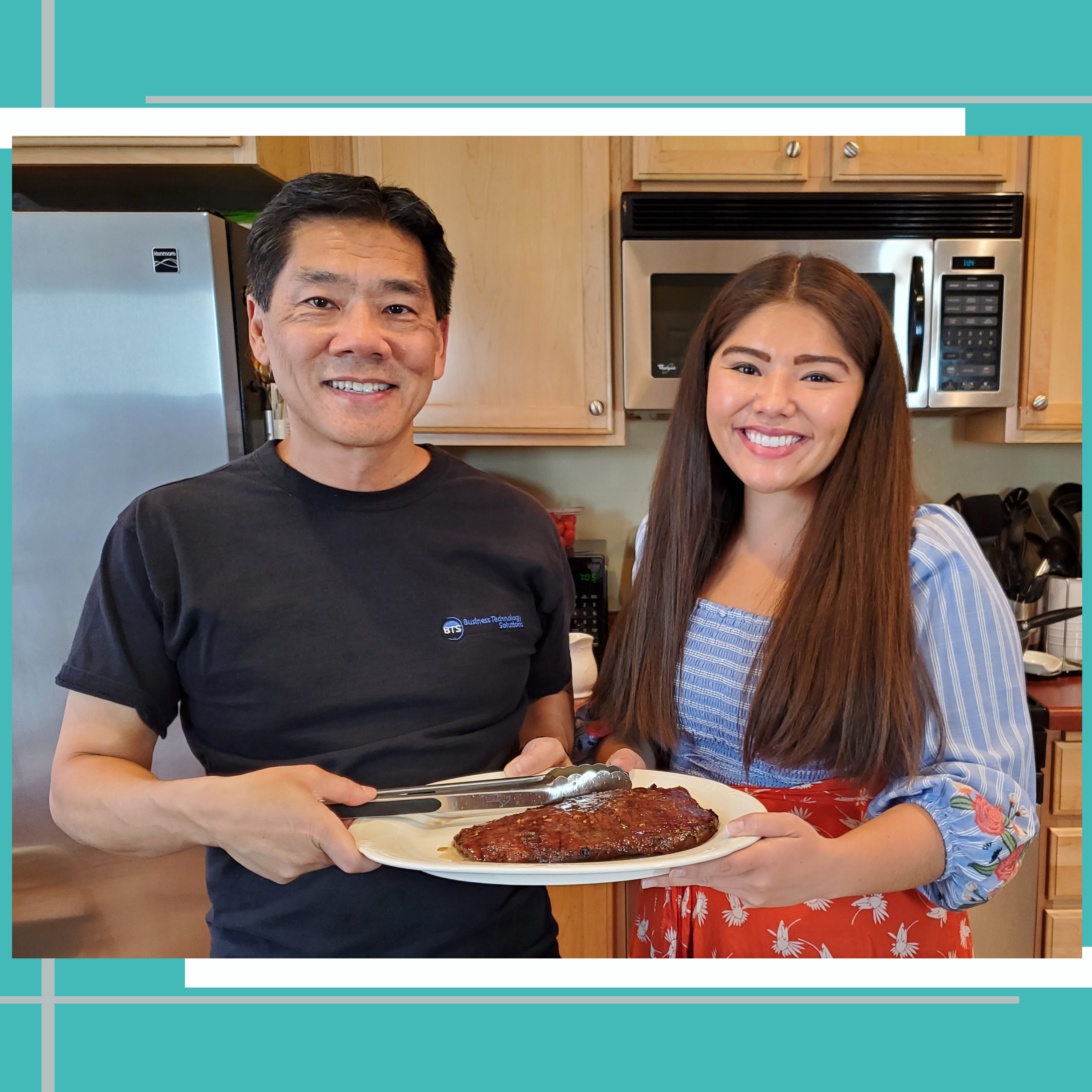 My dad and I holding our grilled Asian Flank Steak