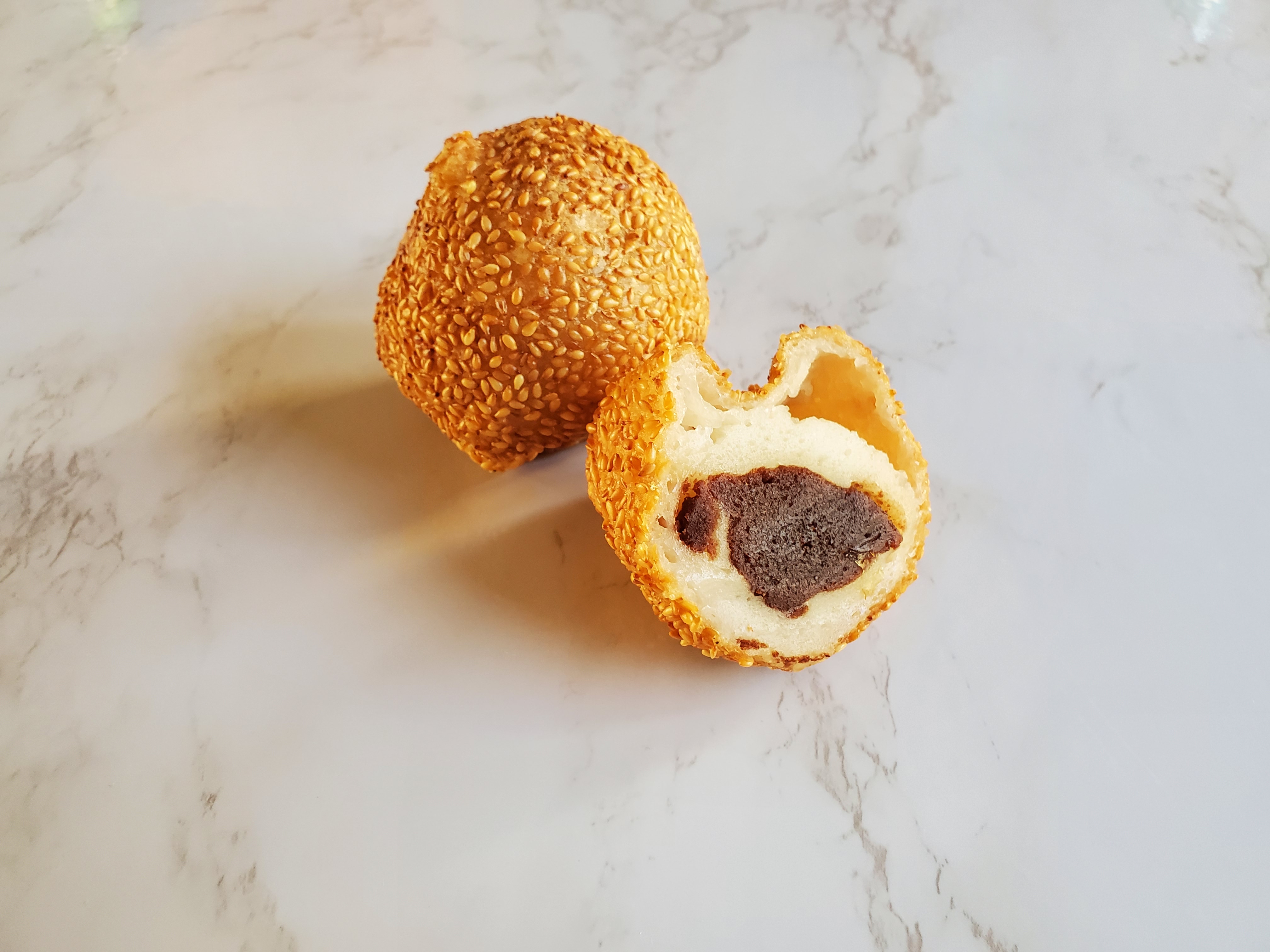 red bean sesame balls on a white countertop